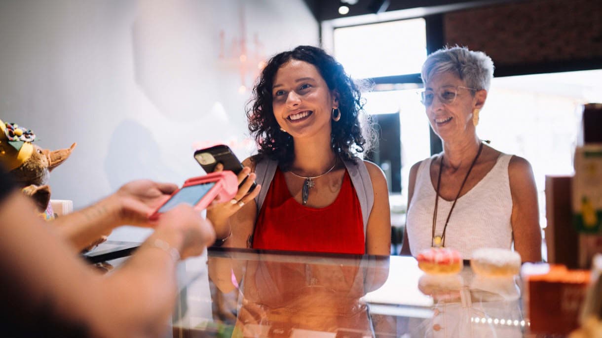 Customer paying with phone at shop